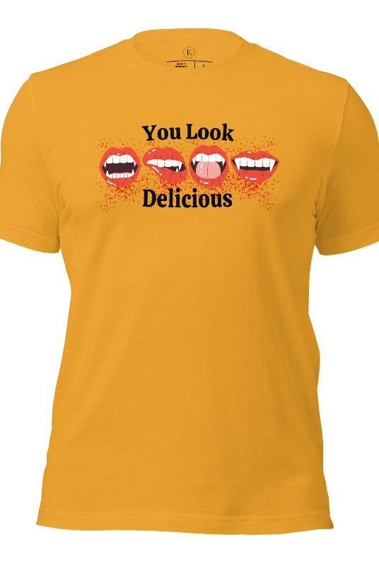 Indulge in wickedly delightful style with our vampire lips shirt. Featuring alluring lips dripping with Halloween allure, this shirt captivates with its seductive charm. The cheeky message, 'You Look Delicious,' on a mustard colored shirt. 