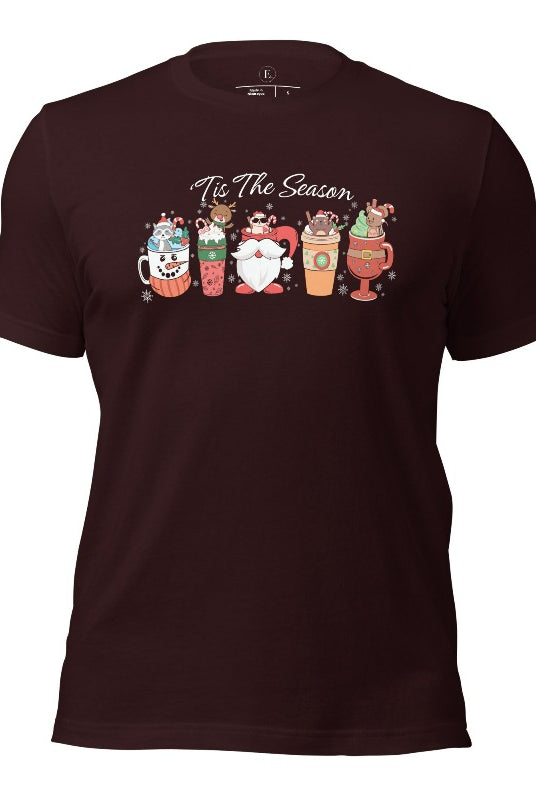 Wrap yourself in cozy holiday vibes with our Christmas coffee cup shirt. With a festive design that says "Tis The Season," this shirt captures the essence of warmth and joy on this oxblood black colored shirt. 