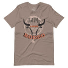 Unleash your cowboy spirit with our country western t-shirt boasting the statement "Not my First Rodeo" alongside bold bull horns and a lasso design on a pebble shirt. 