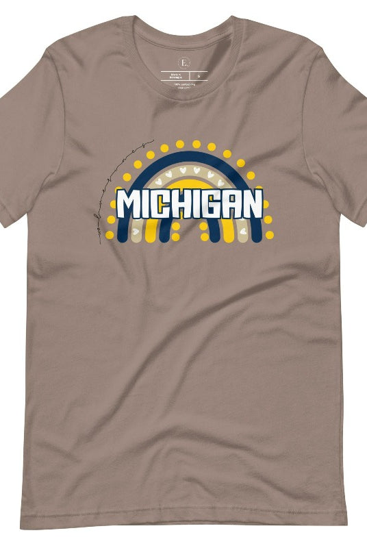 Unleash your vibrant spirit with our Michigan graphic tee. Adorned with a rainbow in school colors and "Michigan" in playful block bubble lettering, this shirt exudes energy and Wolverine pride on a pebble colored shirt. 
