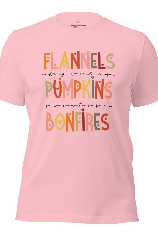 Embrace the cozy spirit of fall with our Flannel, Hayrides, Pumpkins, Sweaters, Bonfires shirt. Featuring the iconic fall elements, this shirt celebrates the season of warmth and comfort on a pink shirt. 