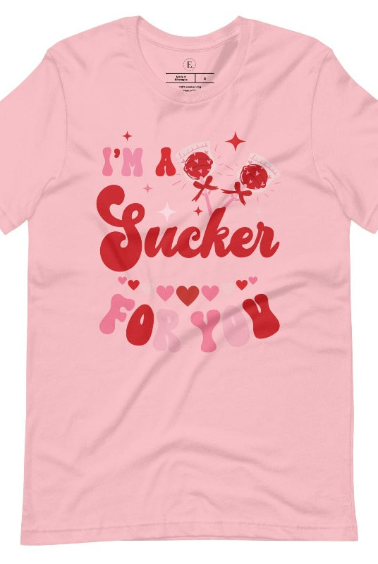Indulge in the spirit of love with our Valentine's Day shirt! Adorned with charming Valentine lollipops and the playful saying, "I'm a sucker for you," on a pink shirt. 