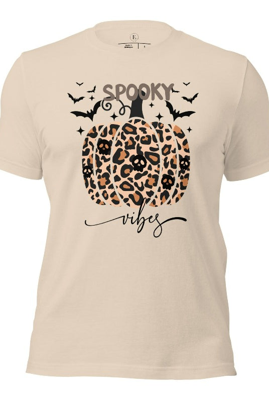 Get into Halloween spirit with our spooky vibes shirt featuring a unique cheetah print pumpkin adorned with skulls. As bats soar across the starry sky, embrace the eerie charm of this one-of-a-kind design on a soft cream colored shirt. 