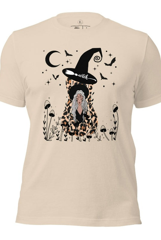 Elevate your Halloween style with our striking shirt featuring a cheetah print squash and a stylish lady donning a witch hat adorned with flowers and bats. Embrace the enchanting fusion of nature and magic on a soft cream colored shirt. 