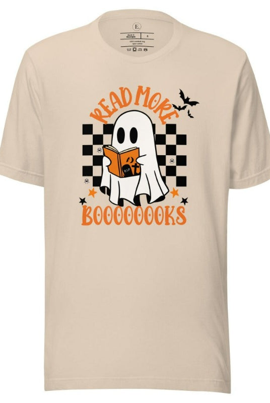 Read More Booooks is a ghost reading a book in front of a checkered background on a soft cream colored shirt.