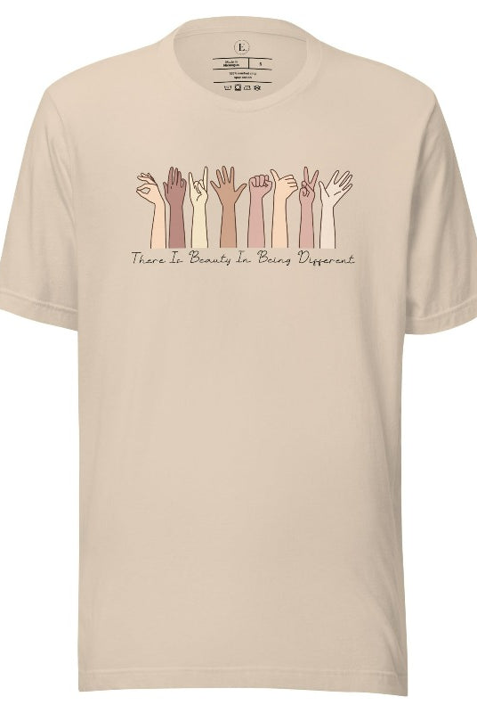 Celebrate diversity with this inspiring shirt, which features hands of different ethnicities and boldly declares "There is beauty in being different" on a soft cream colored shirt.