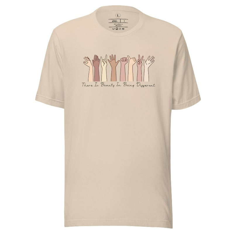 Celebrate diversity with this inspiring shirt, which features hands of different ethnicities and boldly declares "There is beauty in being different" on a soft cream colored shirt.
