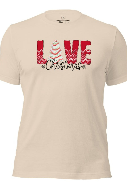 Spread love and joy this holiday season with our Christmas shirt featuring the classic Christmas tree cake, which is incorporated into the word "Love" on a soft cream colored shirt.