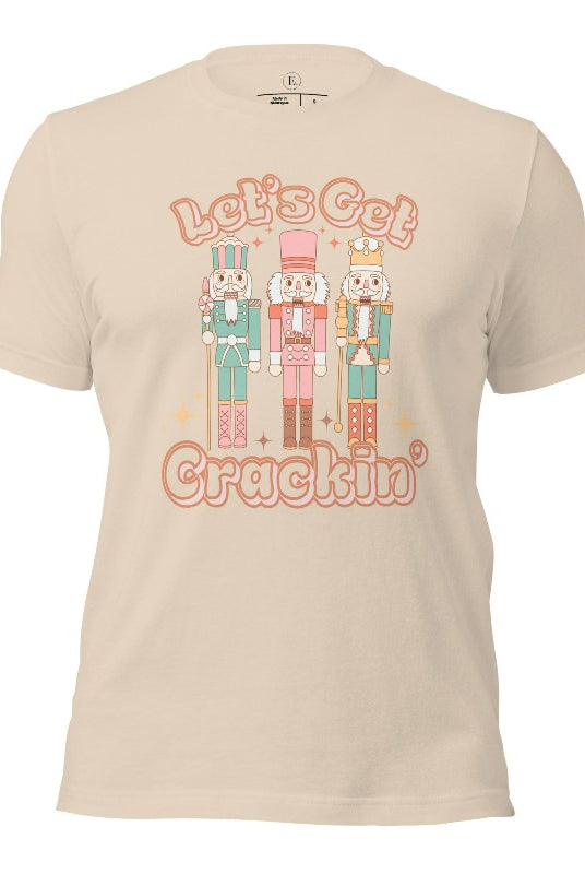 Get into the festive groove with our Christmas Nutcracker shirt that exclaims, "Let's Get Crackin'!" on a soft cream colored shirt. 
