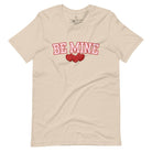 Elevate your Valentine's Day style with our "Be Mine" shirt! Featuring bold athletic lettering and three adorable hearts, on a soft cream shirt. 