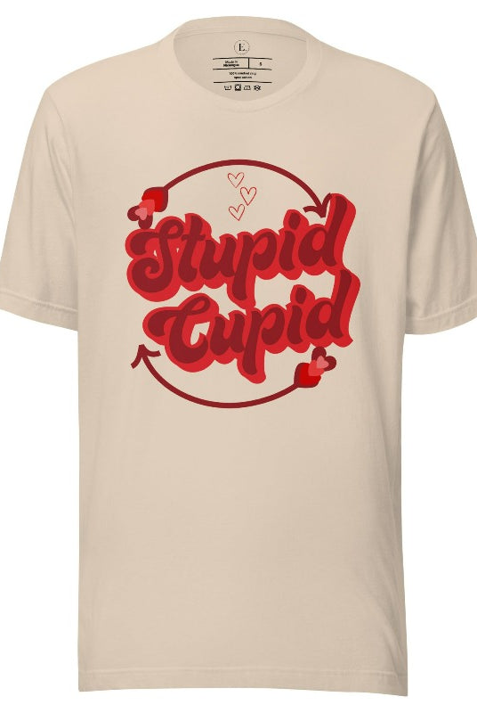 Express your Valentine's Day attitude with our bold and cheeky shirt proclaiming "Stupid Cupid" on a soft cream shirt. 