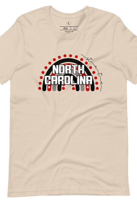 Looking for a way to show off your vibrant spirit? Look no further than this NC State University t-shirt. The NC State colors shine on a boho rainbow backdrop, representing the iconic North Carolina wordmark in a unique and trendy way on a soft cream shirt. 