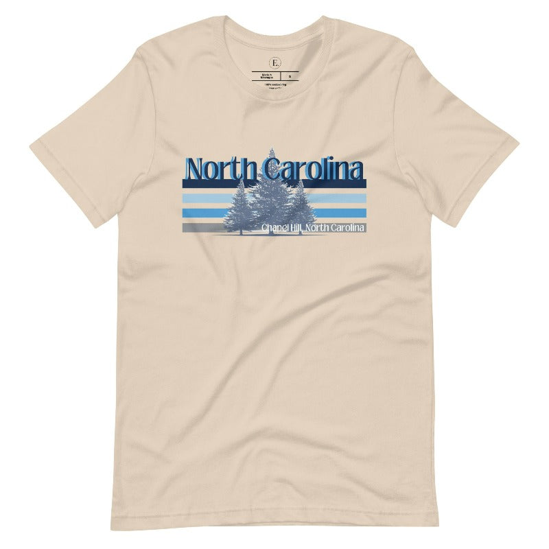 Show your school pride with this iconic North Carolina wordmark t-shirt. Made from premium materials, it features a North Carolina tree line in a the cool Carolina blue colors, representing a tradition of excellence for the nature that North Carolina offers on a soft cream shirt. 