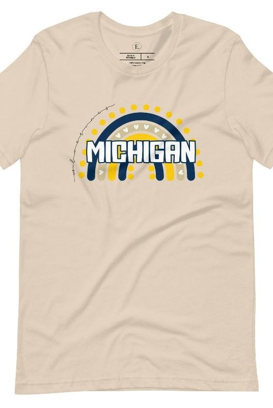 Unleash your vibrant spirit with our Michigan graphic tee. Adorned with a rainbow in school colors and "Michigan" in playful block bubble lettering, this shirt exudes energy and Wolverine pride on a soft cream shirt. 
