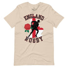 Introducing our England Rugby Graphic T-Shirt - the ultimate fusion of patriotism, rugby pride, and contemporary style! This captivating t-shirt features the words "England Rugby" and the iconic England flag artfully incorporated within the outline of the country, accompanied by a dynamic rugby player graphic on a soft cream colored shirt. 