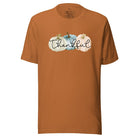 Express gratitude in style with our charming t-shirt. This design radiates autumn appreciation, featuring three pastel pumpkins and the word 'thankful' gracefully woven through the middle on a toast colored shirt. 