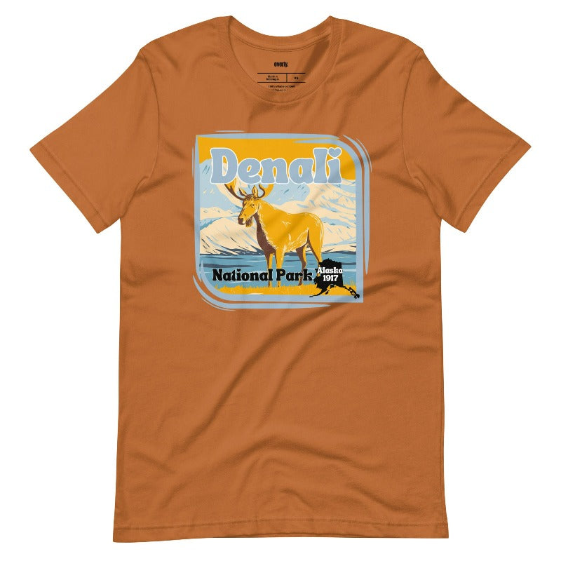 Toast Bella + Canvas 3001 t-shirt featuring a colorful Denali National Park graphic with a moose and mountains, showcasing the beauty of Alaska's wilderness.