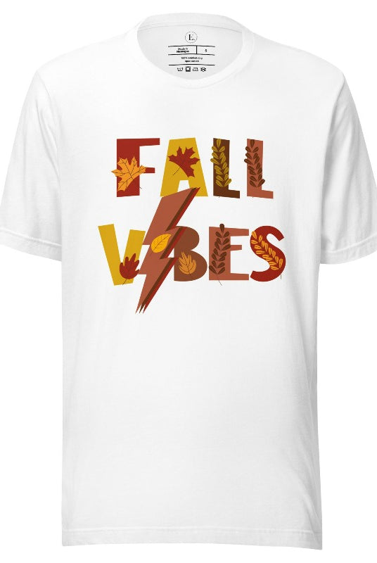Get into the autumn spirit with our Fall Vibes shirt. Featuring the words 'Fall Vibes' with a creative twist- a lighting bolt replacing the 'I'- this shirt captures the energy of the season. Adorned with leaves, it adds a touch of nature's beauty on a white shirt. 