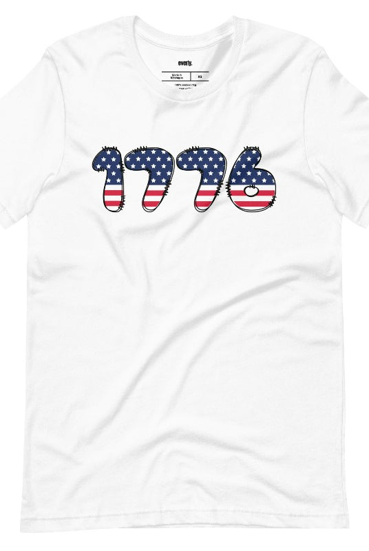 Close-up image of a USA July 4th graphic tee with the number '1776' spelled out in American flag inspired numbers on the front. This patriotic tee is perfect for celebrating Independence Day in style and showing off your love for America on a white graphic tee.