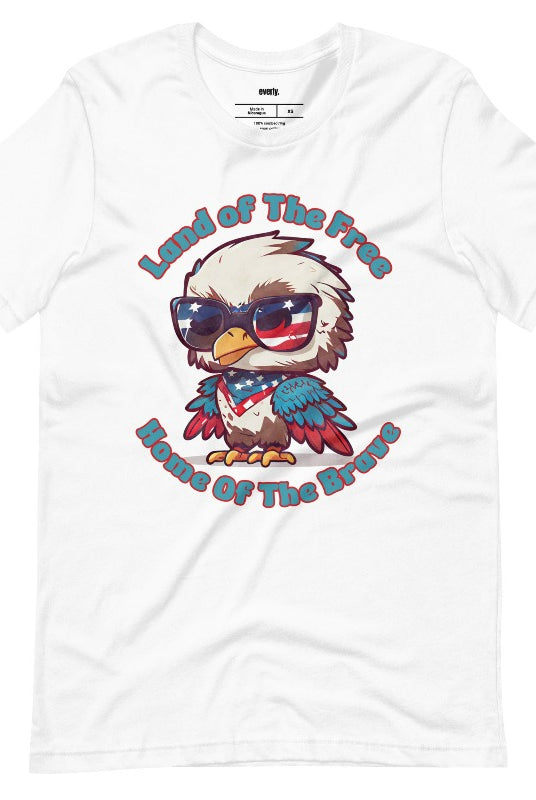 Graphic of a bird wearing sunglasses and a USA-themed scarf, with the text 'Land of the Free, Home of the Brave' on the front of the t-shirt on a white graphic tee. 