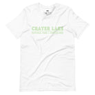 A vibrant design of Crater Lake National Park on the back, showcasing the lake and surrounding mountains in colorful hues, with the text "Crater Lake National Park | Oregon 1902" on the front. This design is on a white shirt. 