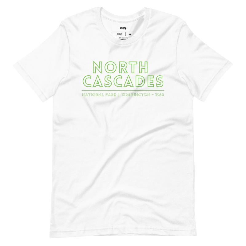 a vibrant, retro-style design of North Cascades National Park on the back, and "North Cascades National Park | Washington - 1968" text on the front on a white shirt.