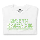 a vibrant, retro-style design of North Cascades National Park on the back, and "North Cascades National Park | Washington - 1968" text on the front on a white shirt.