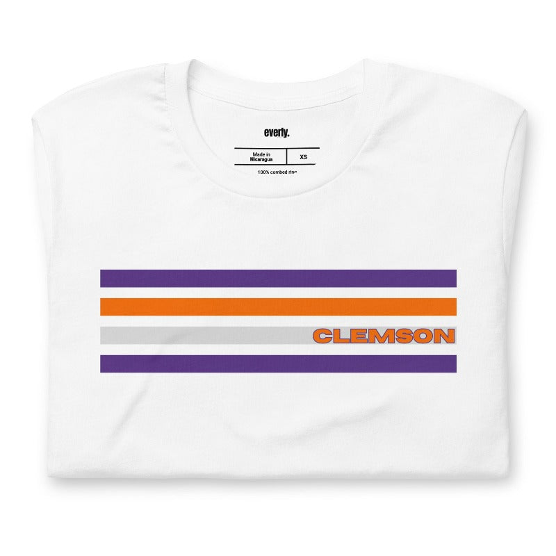 Bella + Canvas 3001 unisex T-shirt featuring a Clemson University design with purple, orange, and grey stripes and the word "Clemson" in bold orange letters on a white shirt