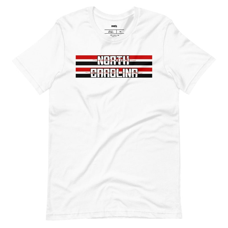 "North Carolina" in bold red and white text on a black and red striped background across the chest on a white shirt. 