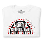 This vibrant NC State design with "North Carolina" text, rainbow arch, and red dots on a white shirt.