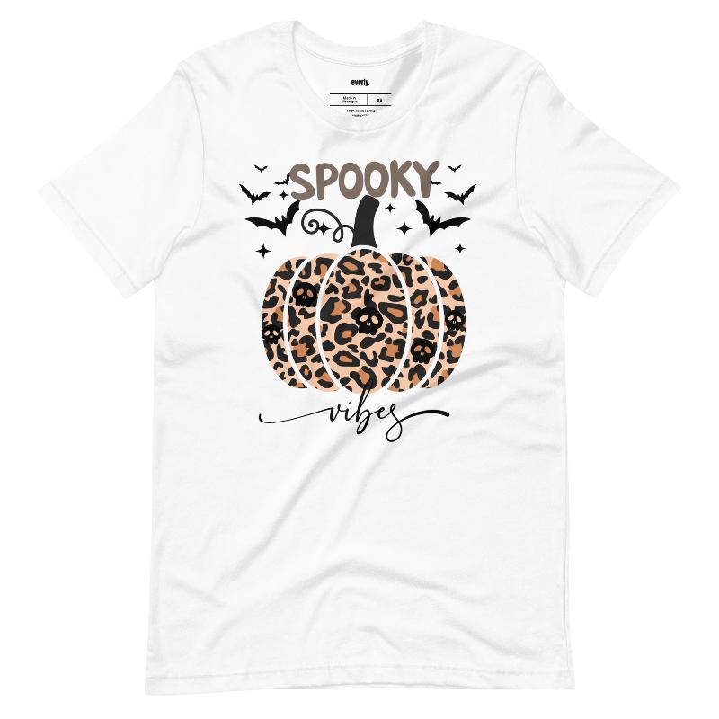 White t-shirt featuring a leopard-print pumpkin and "Spooky Vibes" text surrounded by bats, perfect for Halloween and fall season style.