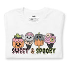 White t-shirt featuring a fun 'Sweet & Spooky' design with Halloween-themed ice cream cones, skulls, pumpkins, and spooky treats.