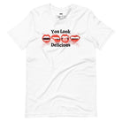 White t-shirt featuring a graphic of fanged red lips with the playful phrase "You Look Delicious" splattered in red, perfect for Halloween.