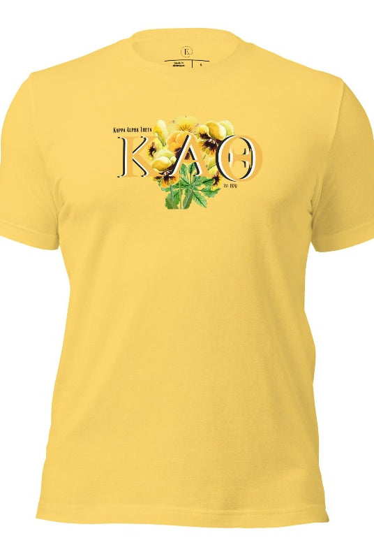 Show your Kappa Alpha Theta pride with our sorority t-shirt! Our design features the sorority letters and a striking black and gold pansy, symbolizing sisterhood and strength on a yellow shirt. 