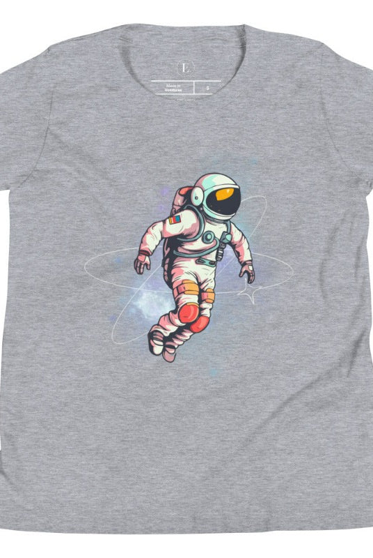 Embark on an intergalactic adventure with our captivating kids' shirt! Featuring a whimsical design of an astronaut floating in space on an athletic heather grey shirt. 