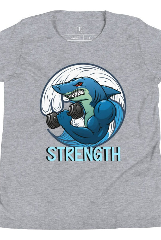 Dive into strength and style with our kids' shirt. Featuring a shark lifting weights with the empowering word 'strength' underneath on an athletic heather grey shirt. 