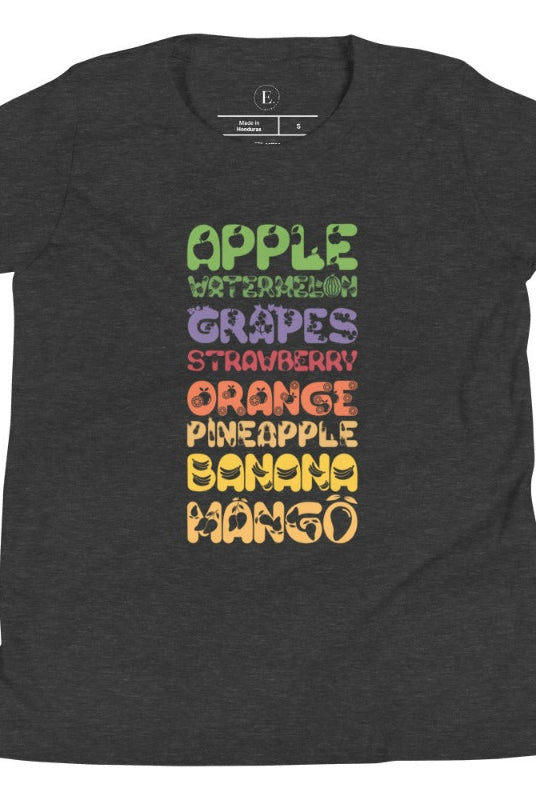 Our kid's shirt adds a burst of fruit fun! It features a colorful list of fruits, promoting healthy eating playfully on a dark grey shirt. 