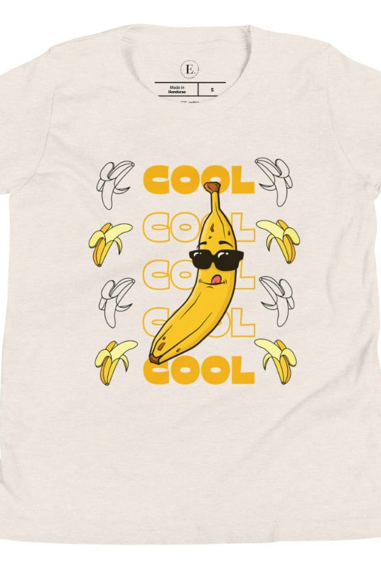 Our kids' shirt is the perfect mix of fun and style, sure to make your little one stand out. It features the word "cool" repeated four times in four rows, topped off with a banana wearing sunglasses on a heather dust colored shirt. 