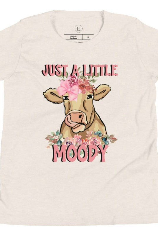 Our kid's shirt features an adorable highland cow with flowers and the quote 'Just a Little Moody,' adding humor and personality to the design on a heather dust colored shirt. 