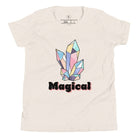 Our kids' shirt is designed to unleash your child's magic. Featuring colorful crystals and the word "Magical", it ignites your child's imagination on a heather dust colored shirt. 