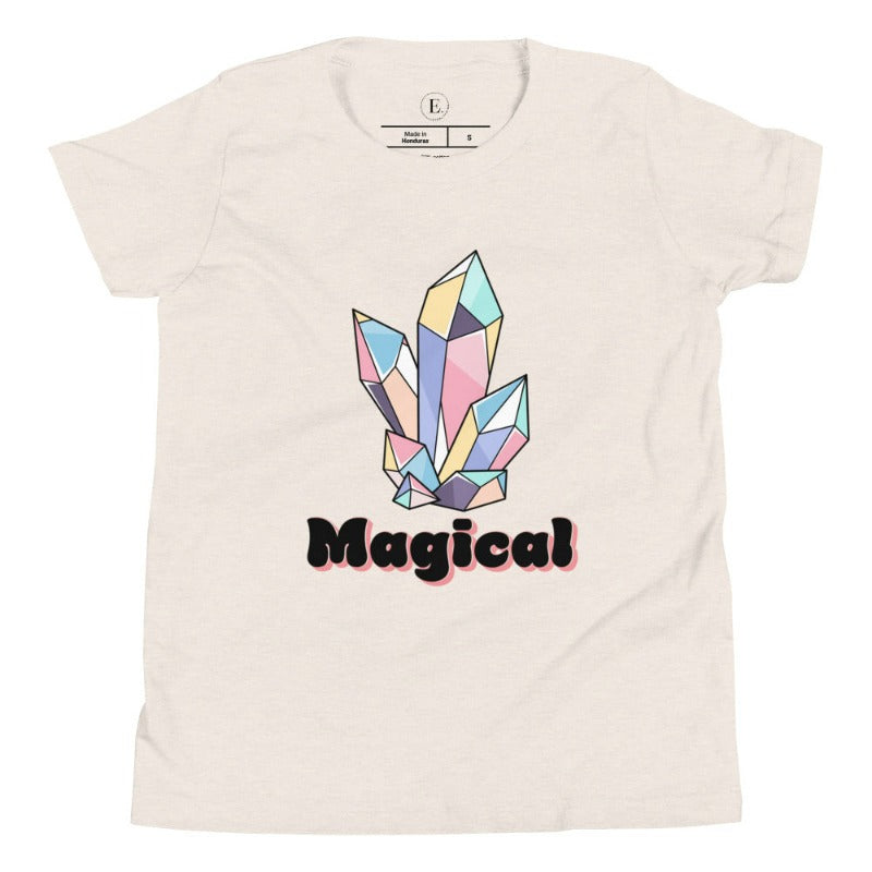 Our kids' shirt is designed to unleash your child's magic. Featuring colorful crystals and the word "Magical", it ignites your child's imagination on a heather dust colored shirt. 