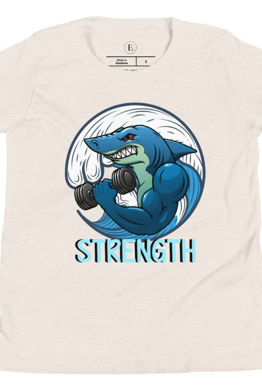 Dive into strength and style with our kids' shirt. Featuring a shark lifting weights with the empowering word 'strength' underneath on a heather dust colored shirt. 