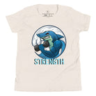 Dive into strength and style with our kids' shirt. Featuring a shark lifting weights with the empowering word 'strength' underneath on a heather dust colored shirt. 