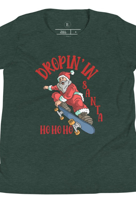 Get your kids in the holiday spirit with our unique, playful tee featuring Santa shredding on a skateboard with the phrase "Dropin' In Santa Ho Ho Ho." On a heather forest green shirt. 