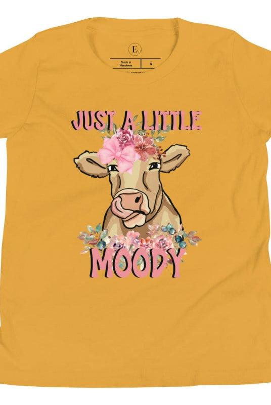 Our kid's shirt features an adorable highland cow with flowers and the quote 'Just a Little Moody,' adding humor and personality to the design on a mustard colored shirt. 